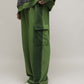 Stylera oversized green cargo pocket joggers with side flap pocket paired with white sneakers