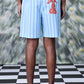 Back view of Stylera striped regular fit shorts light blue white stripes with red rabbit patch