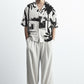 Stylera black and white statement shirt with palm tree graphic print relaxed short sleeve fit on male model