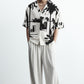 Stylera black and white statement shirt short sleeve camp collar with tropical palm print on male model