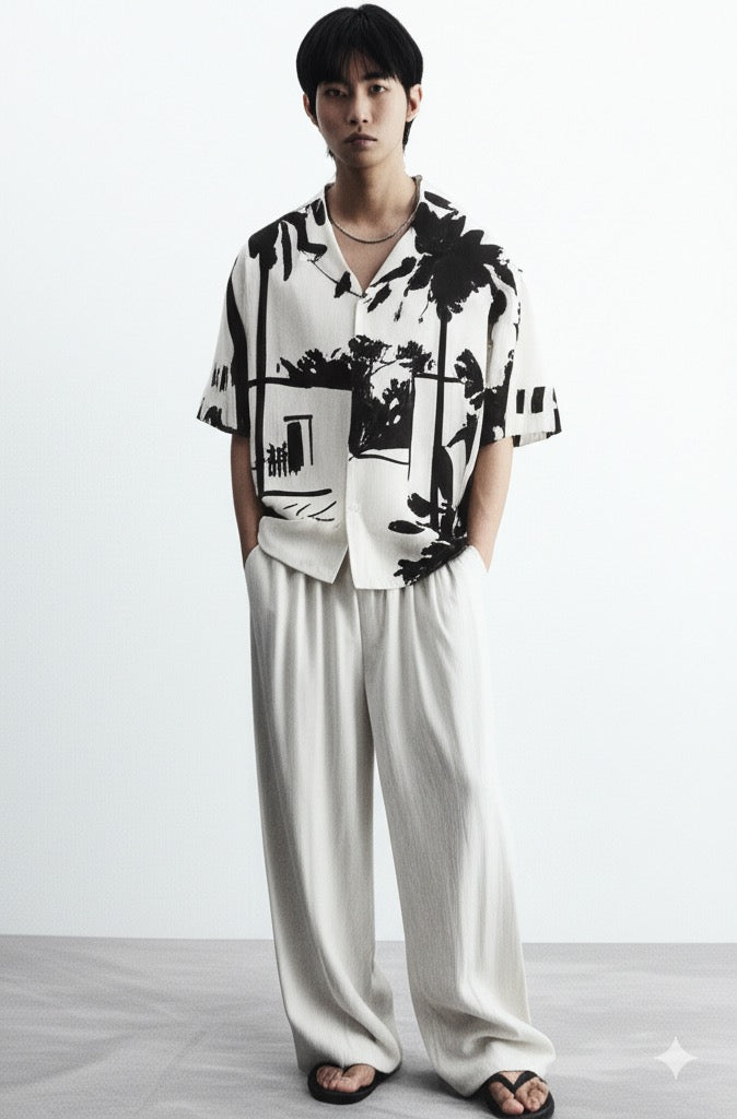 Stylera black and white statement shirt short sleeve camp collar with tropical palm print on male model