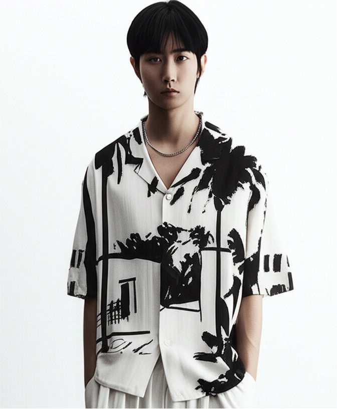Stylera short sleeve button up black and white statement shirt with bold palm graphic print on model