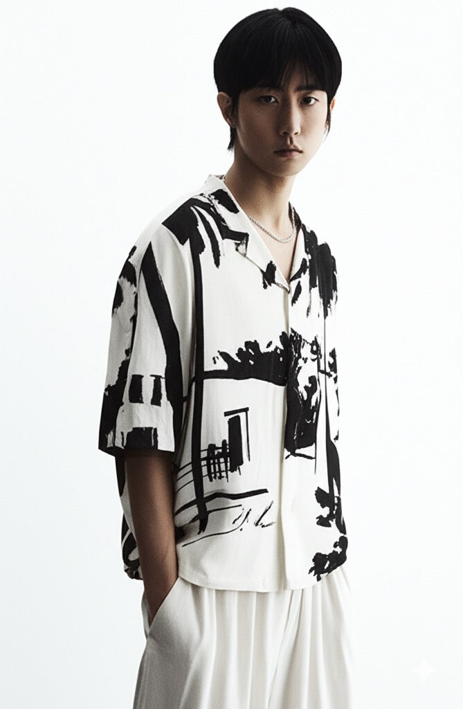 Stylera model wearing a black and white statement shirt short sleeve button down with abstract print
