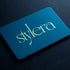 Stylera blue logo card on dark textured surface fashion gift card for stylish shoppers and accessory lovers
