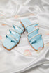 Stylera blue pearl strap sandals with multiple straps and pearl detailing on satin background