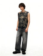 Person wearing a sleeveless studded leather vest and jeans on a white background