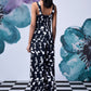 Back view of Stylera black and white patterned long dungaree with wide straps stylish casual dungarees for women