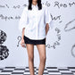 Model wearing Stylera white oversized shirt with puff sleeves and pastel embroidery stylish casual embroidered top
