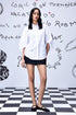 Model wearing Stylera white oversized shirt with puff sleeves and pastel embroidery stylish casual embroidered top