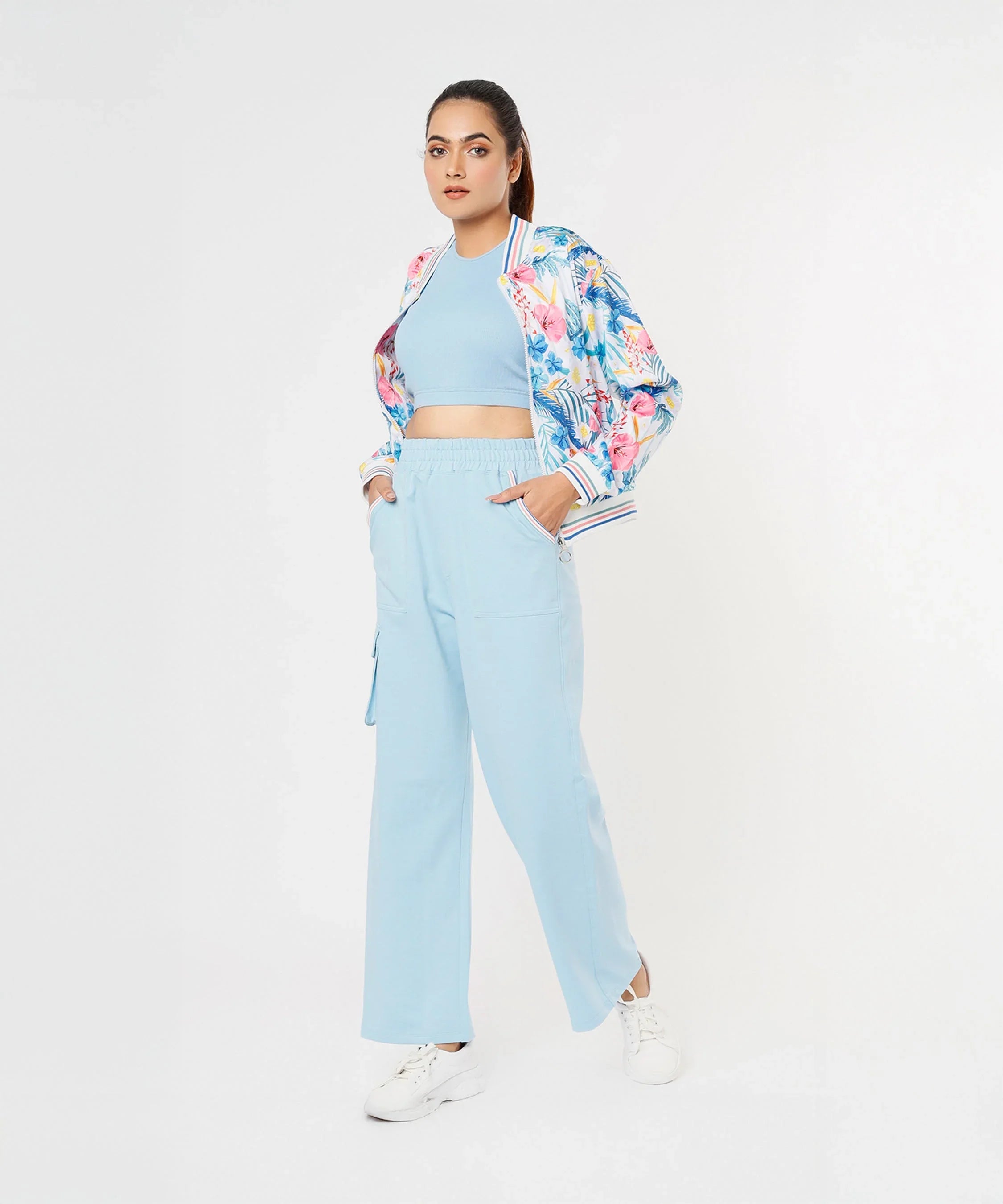 Trendy model wearing stylish co ord sets for women, featuring a floral bomber jacket and light blue pants