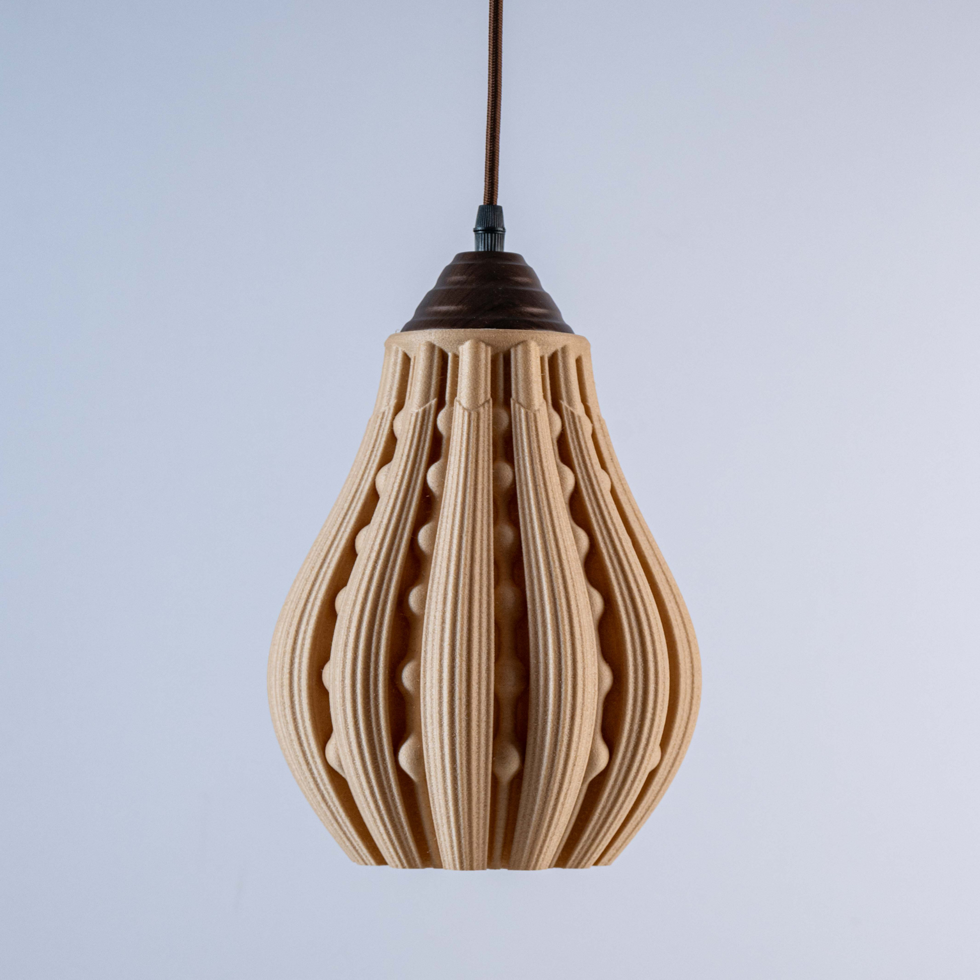Stylish decorative hanging lamp with unique ribbed design and brown cap, perfect for modern interiors