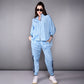 Model wearing a stylish denim track suit in light blue with sporty details and a relaxed fit