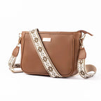 Stylish everyday sling bag in brown with decorative strap for daily use and versatility