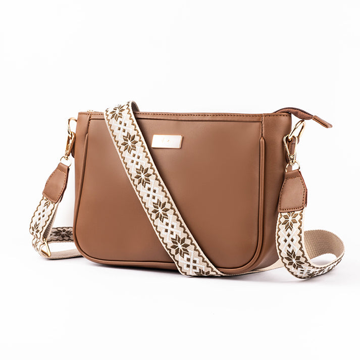 Stylish everyday sling bag in brown with decorative strap for daily use and versatility