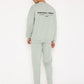 Stylera sage green sweatshirt back view on model with logo and matching pants stylish graphic sweatshirts for camping