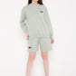 Stylera wearing mint green sweatshirt and shorts featuring eye graphic stylish graphic sweatshirts for camping