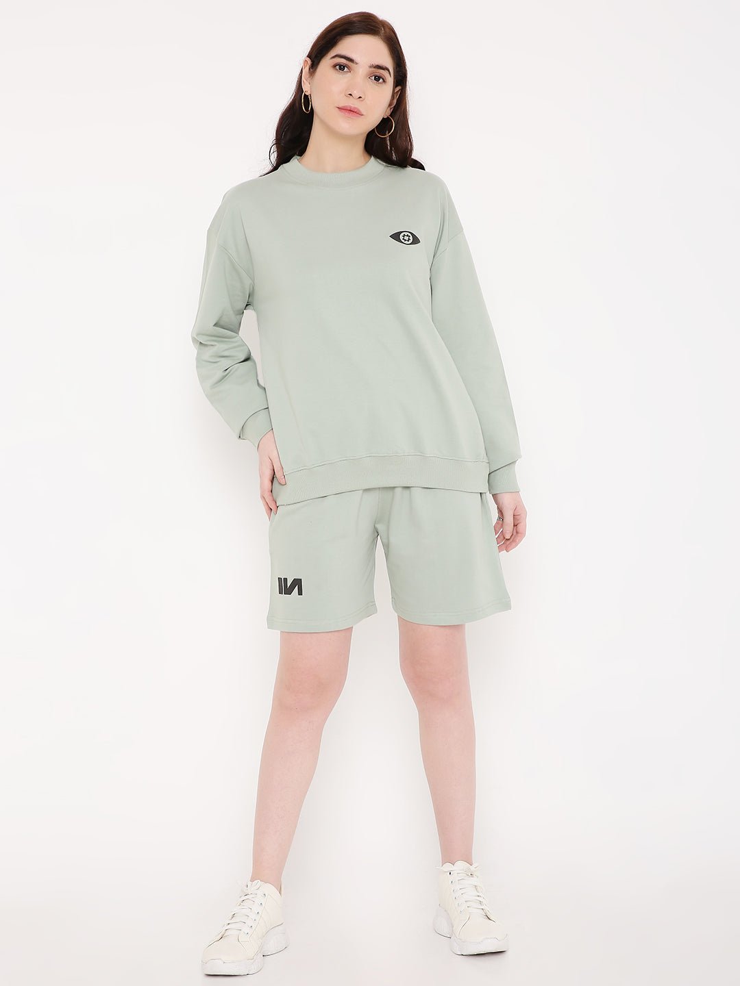 Stylera wearing mint green sweatshirt and shorts featuring eye graphic stylish graphic sweatshirts for camping
