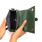 Stylish green purse with gold chain, featuring a spacious interior and elegant design for everyday use