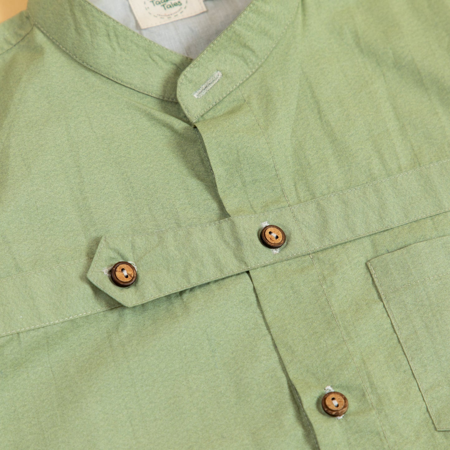 Stylish olive button up shirt with wooden buttons and a modern collar design from Stylera
