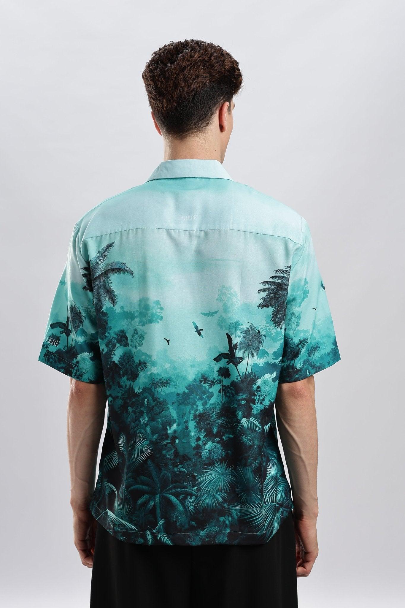 Back view of model wearing Stylera teal palm print stylish short sleeve resort shirt with relaxed fit