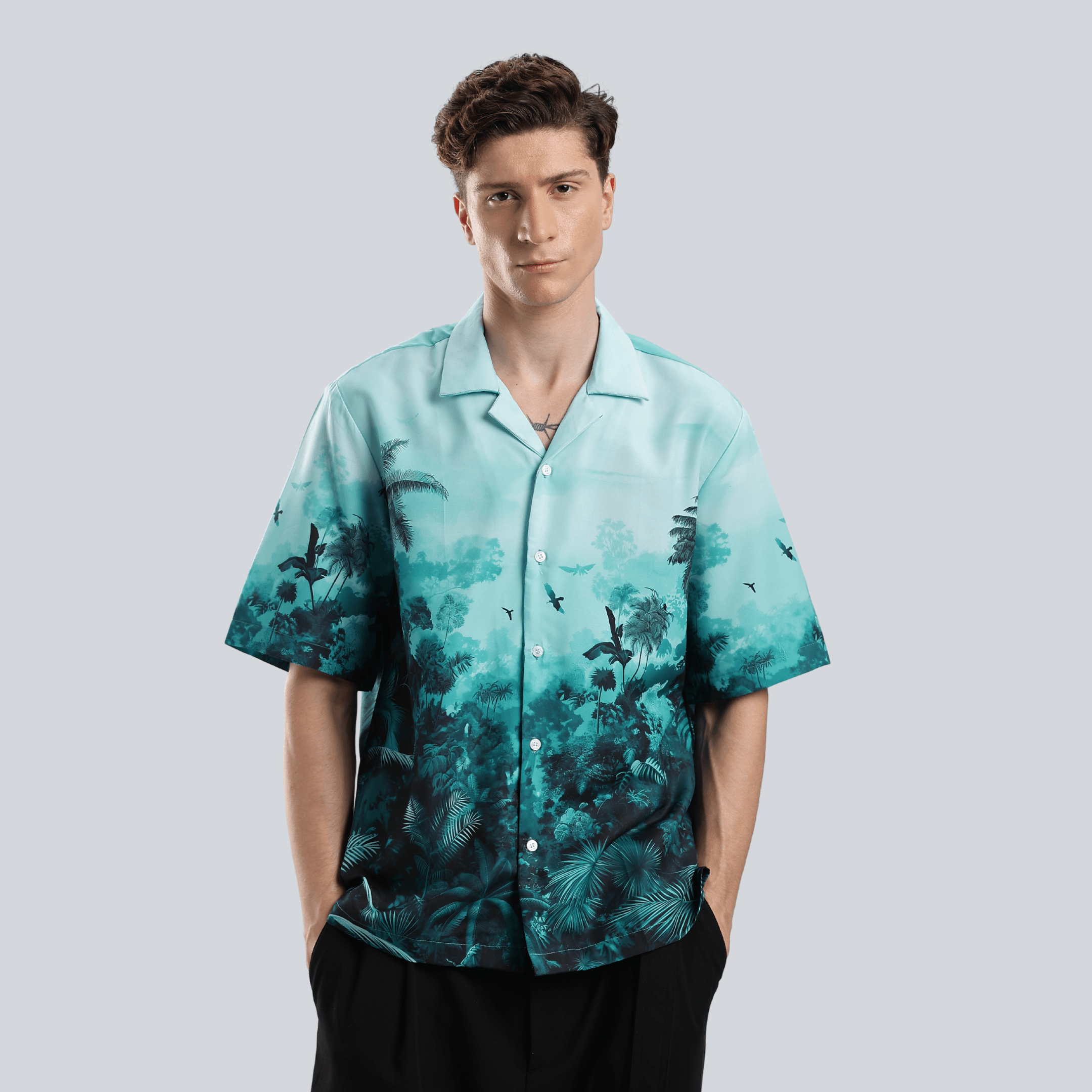Stylera stylish short sleeve resort shirt teal tropical gradient with camp collar on male model wearing black pants