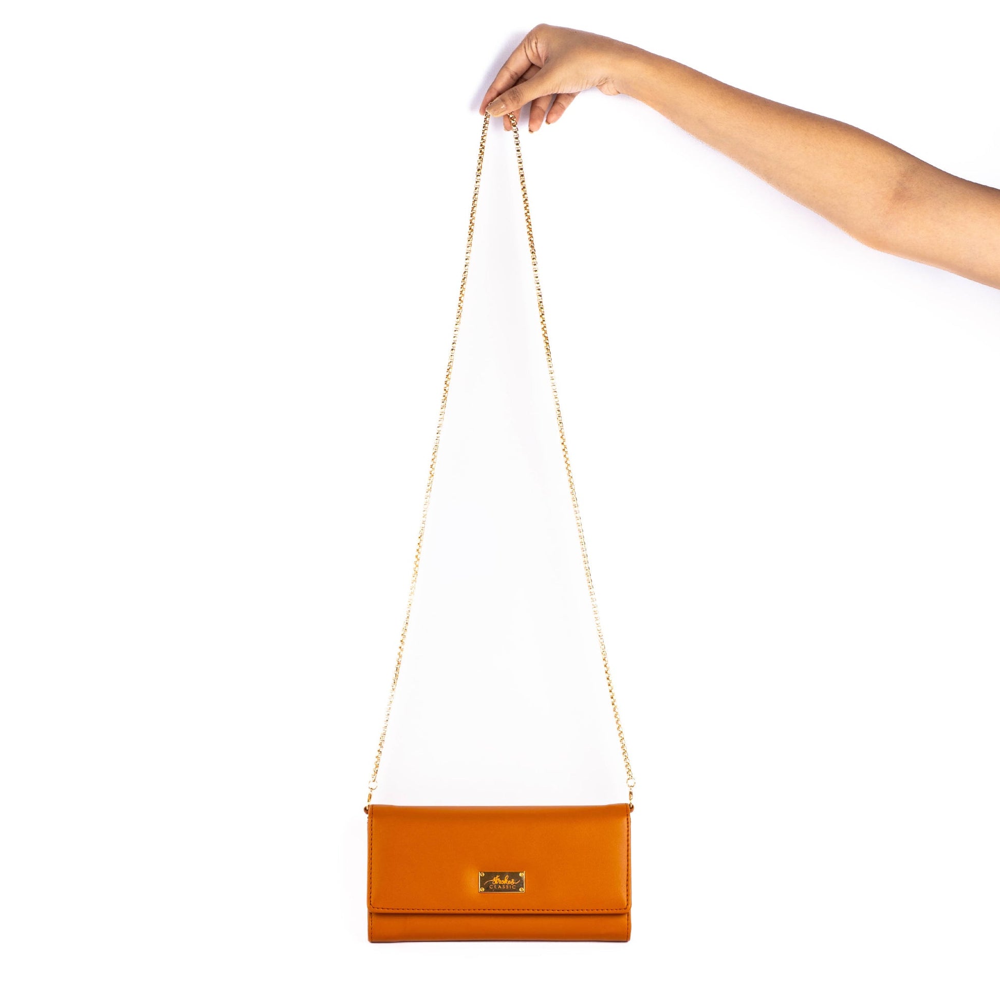 Stylish tan evening bag with a removable chain strap for versatile use as a clutch or sling