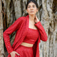 Elegant red stylish three piece set for parties featuring a crop top, long jacket, and matching pants