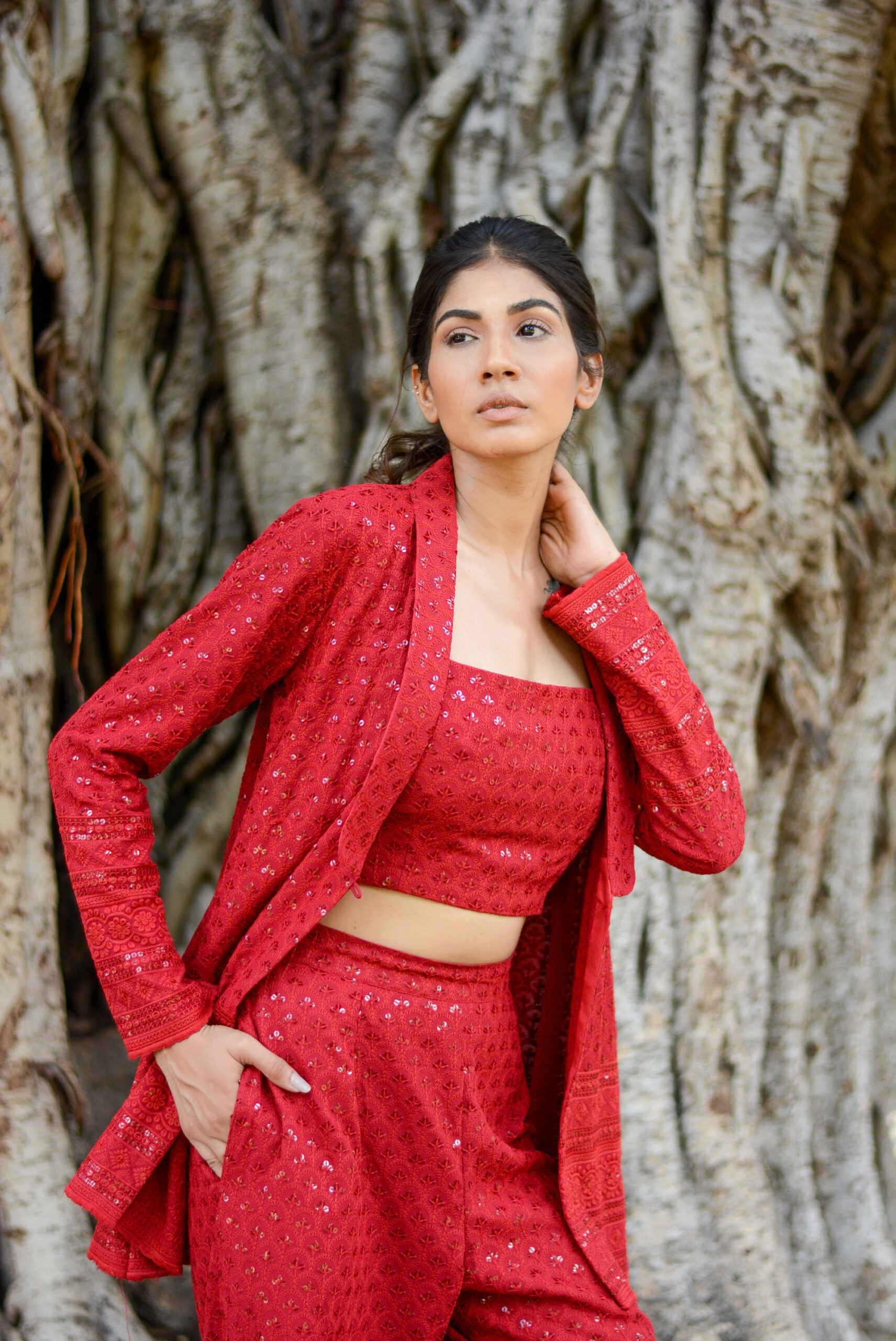 Elegant red stylish three piece set for parties featuring a crop top, long jacket, and matching pants