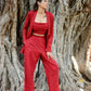 stylish three piece set for parties featuring a crop top, tailored pants, and a matching jacket