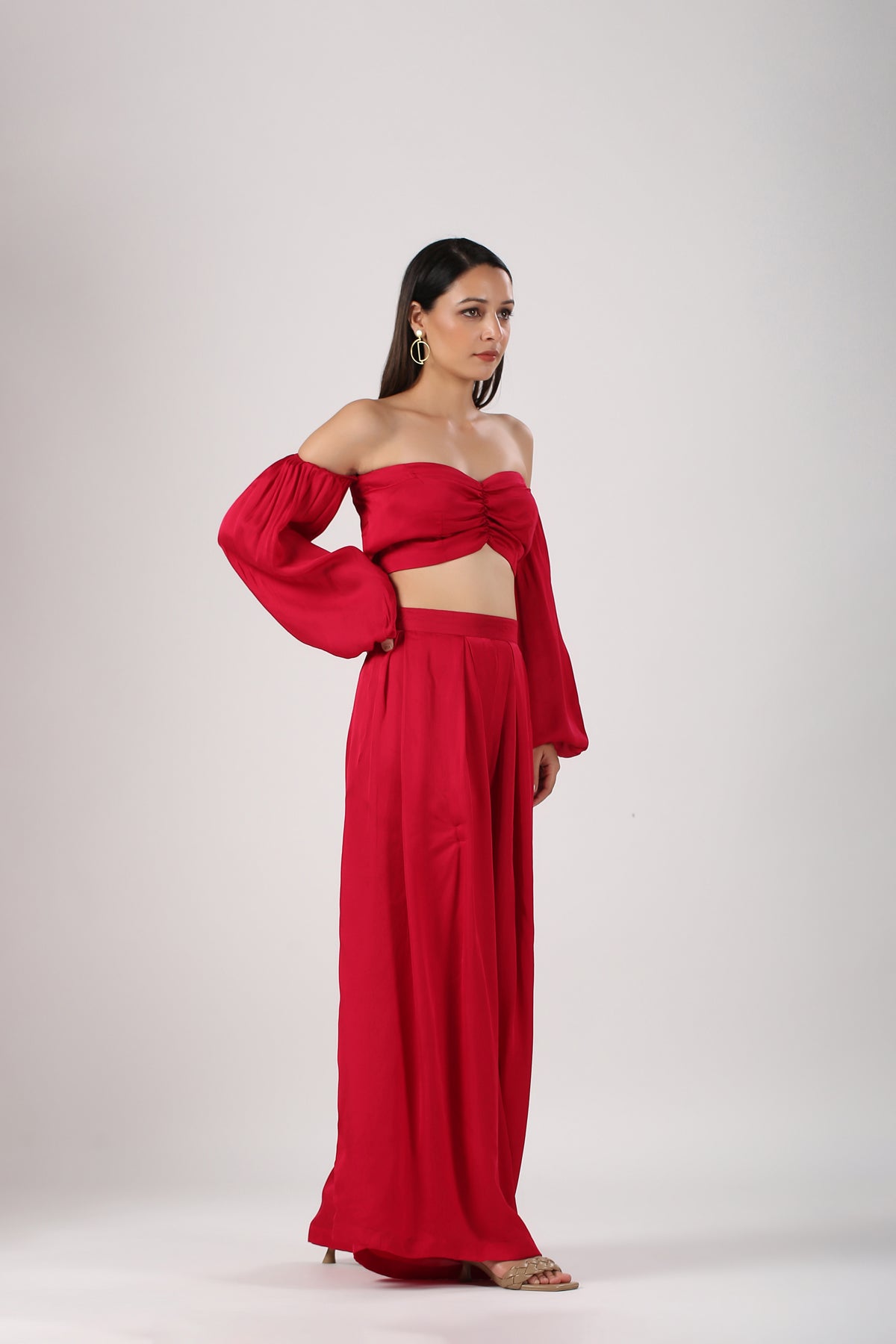 Trendy matching sets for women in red featuring a crop top with puff sleeves and wide-leg pants