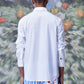 Back view of a man wearing a stylish white shirt for men Stylera standing in a blurred floral background