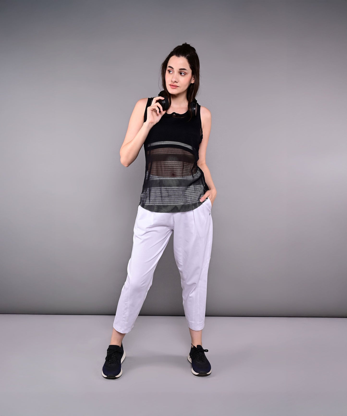 Model wearing stylish yoga pants with pockets and a black tank top for an active lifestyle