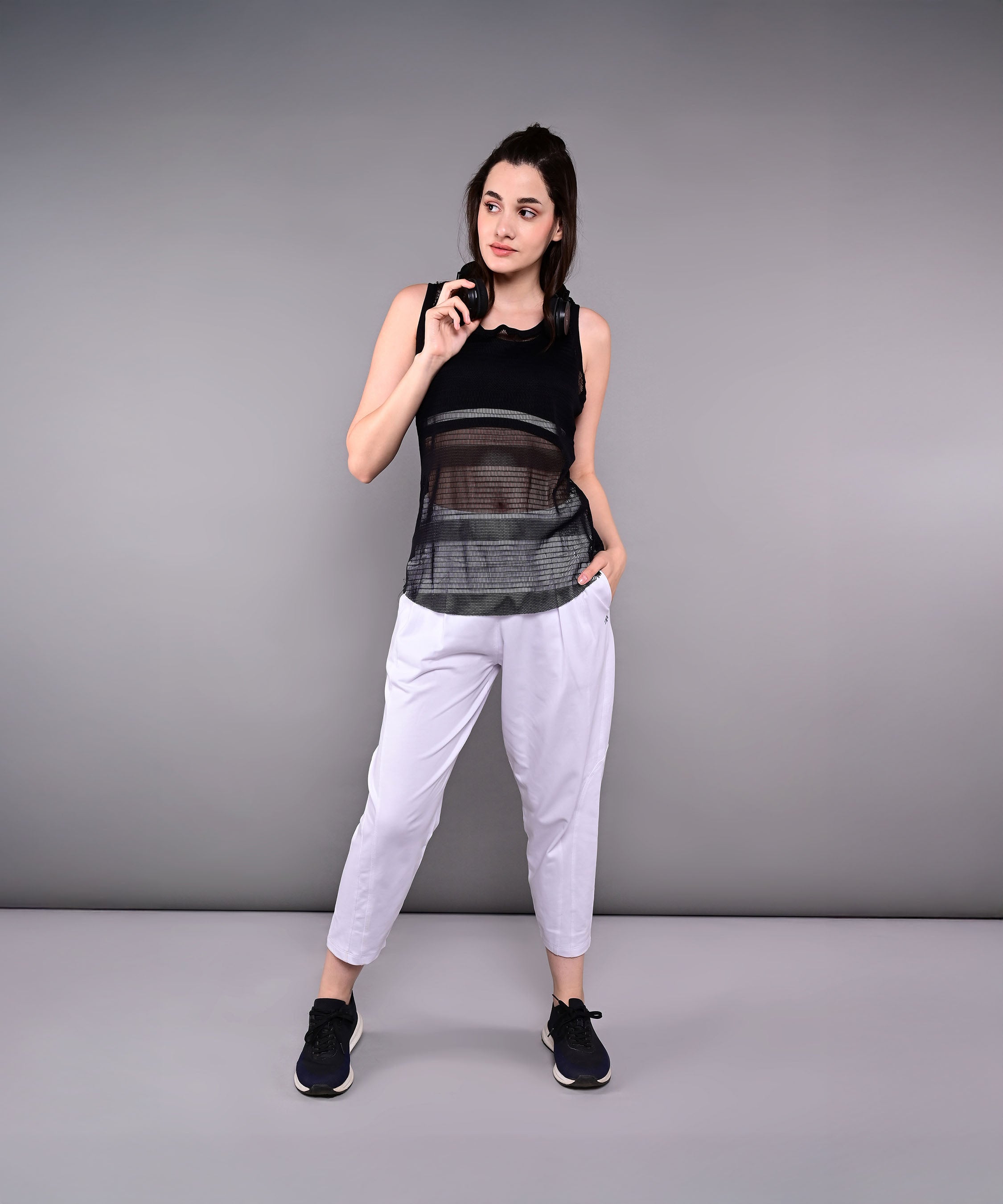 Model wearing stylish yoga pants with pockets and a black tank top for an active lifestyle