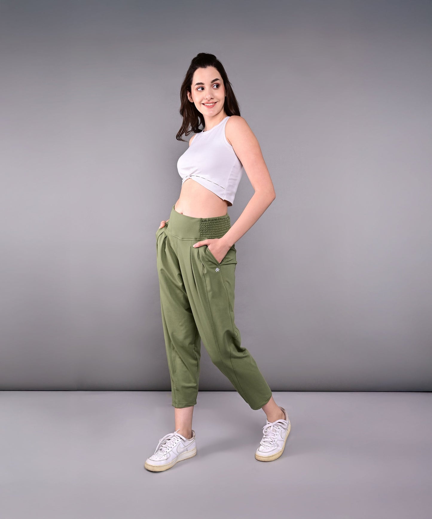 Model wearing stylish yoga pants with pockets in olive green for comfort and functionality