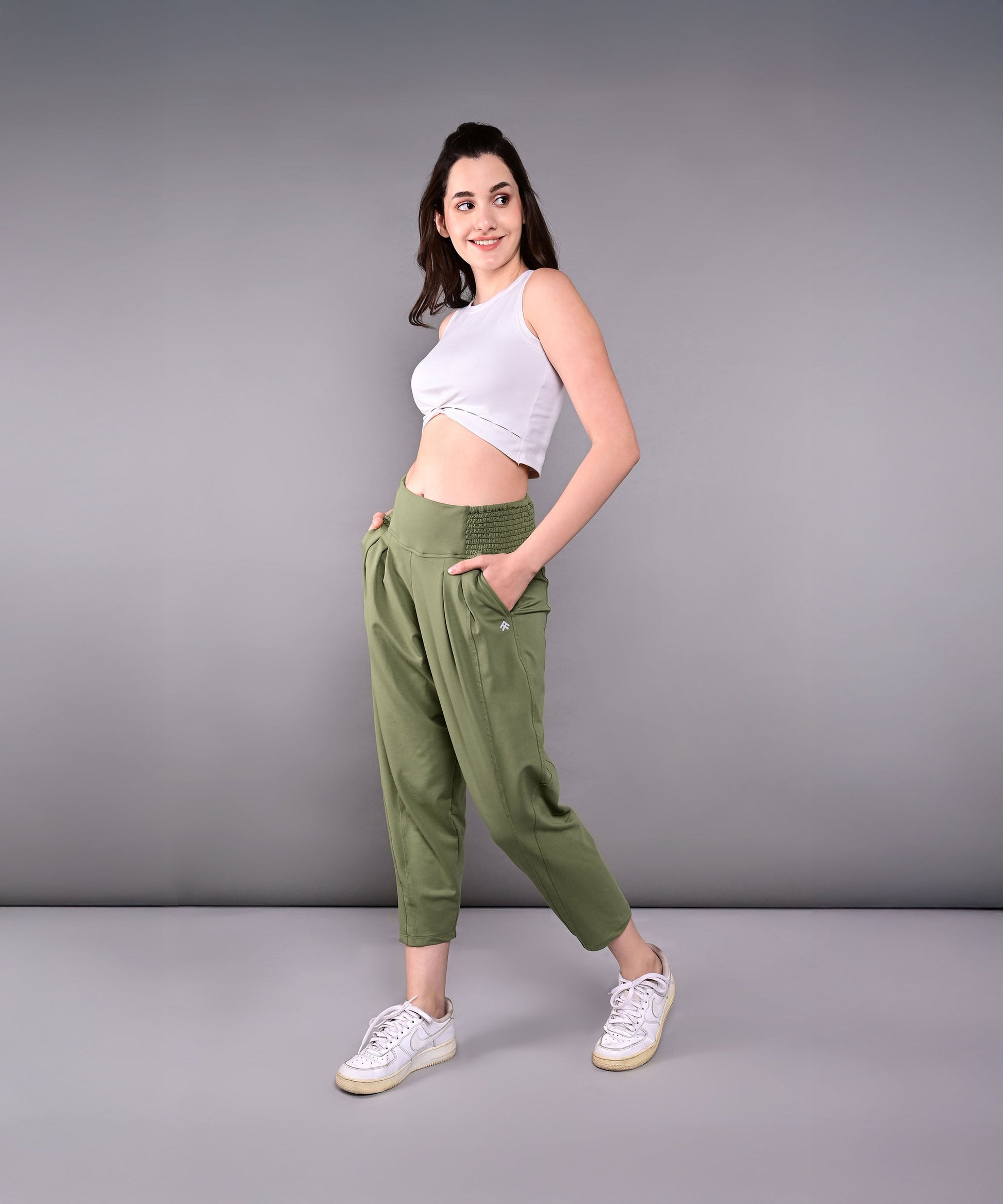 Model wearing stylish yoga pants with pockets in olive green for comfort and functionality