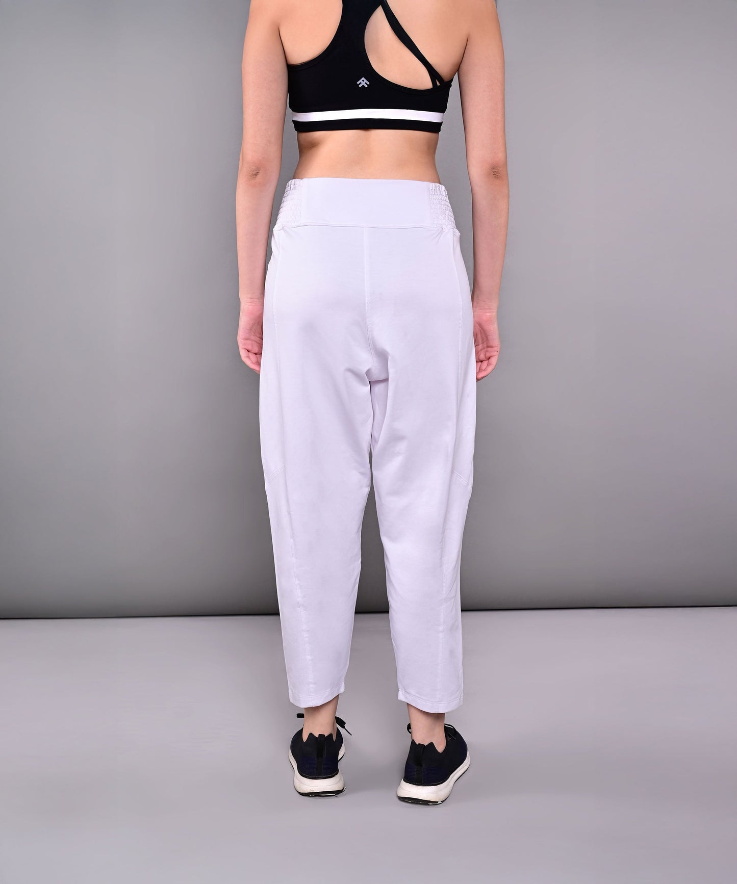 Back view of stylish yoga pants with pockets in light color, perfect for comfort and functionality during workouts