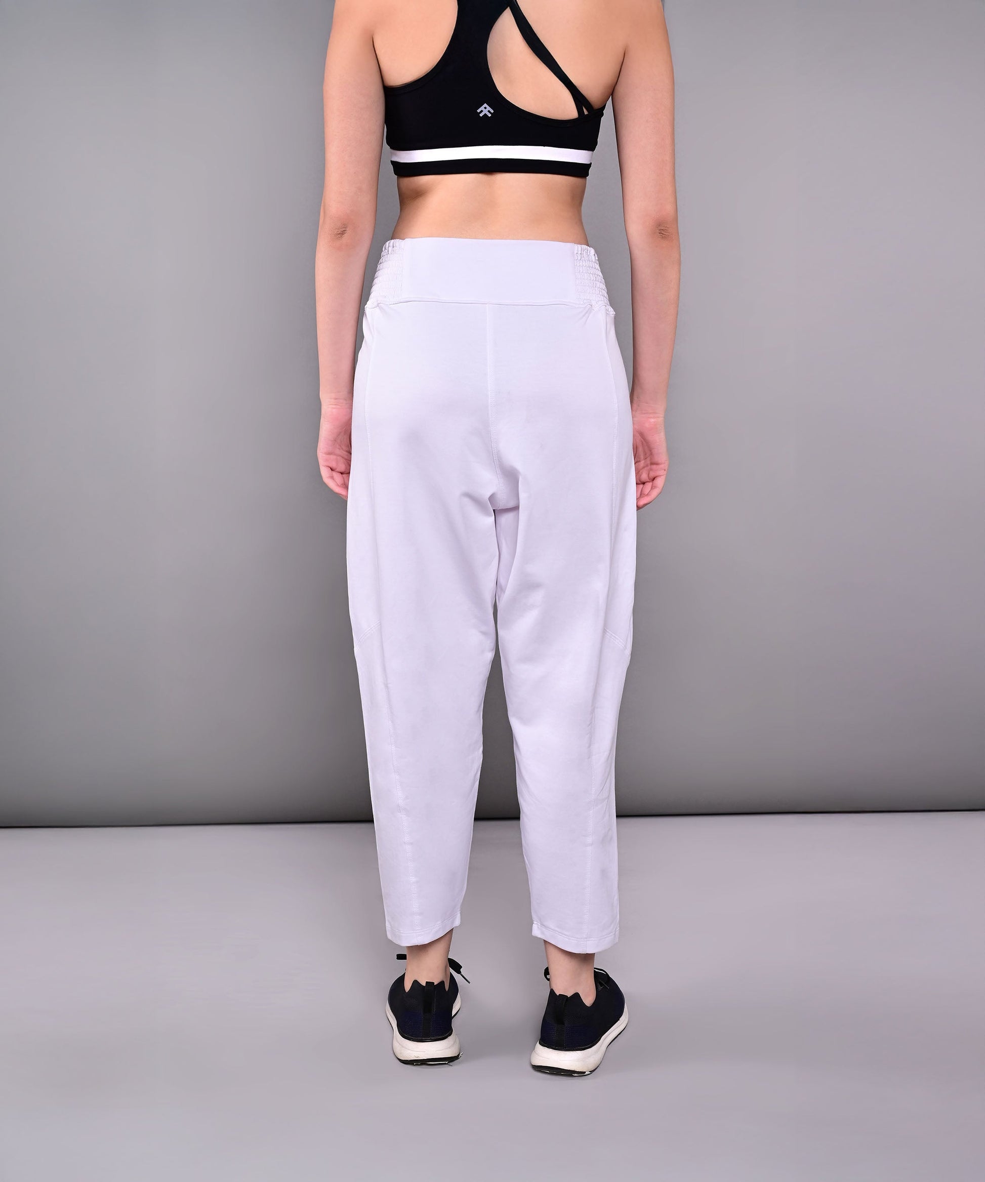 Back view of stylish yoga pants with pockets in light color, perfect for comfort and functionality during workouts