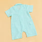 Back view of a teal summer gingham romper outfit with short sleeves and snap closures