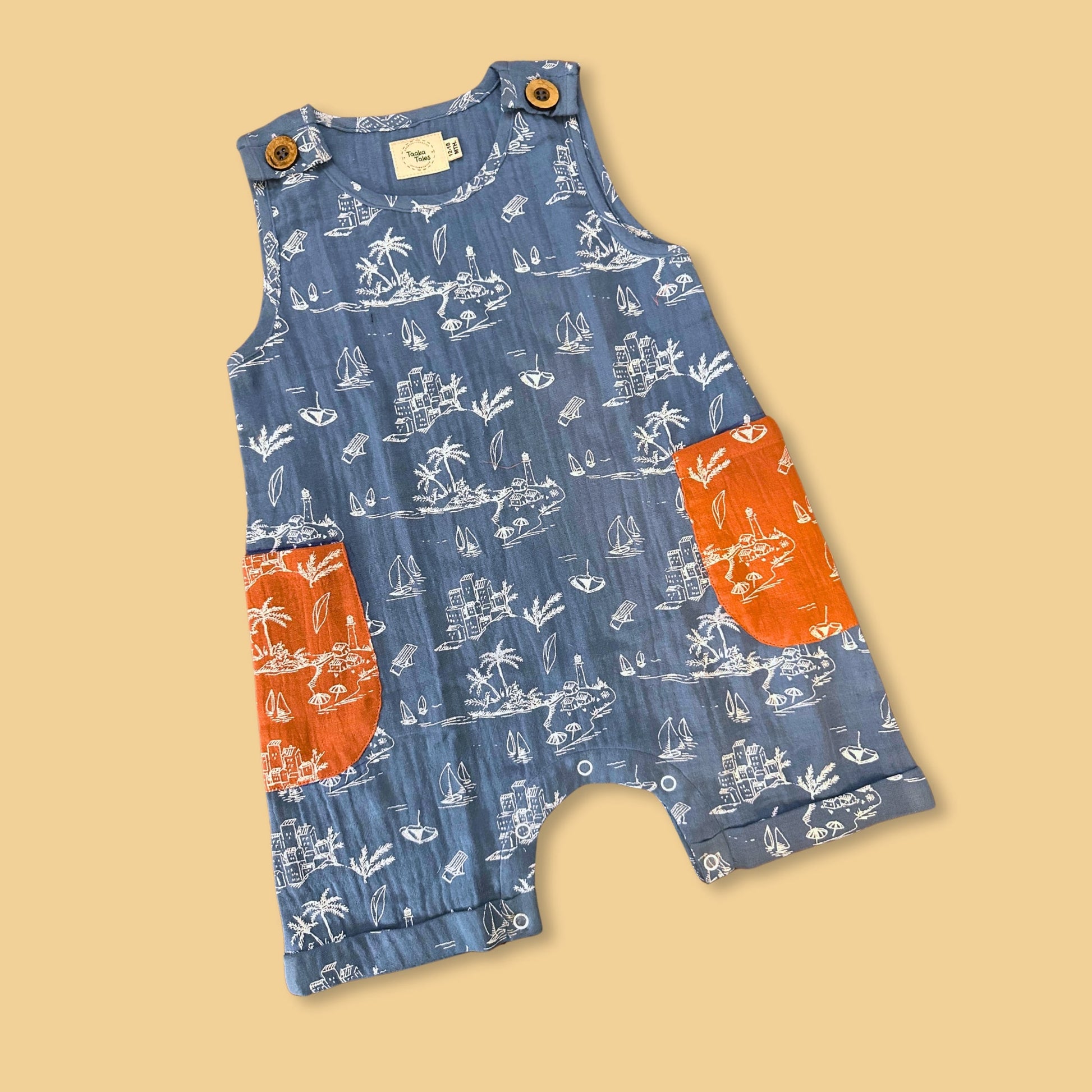 Stylera summer jumpsuit for kids with blue printed design and bright orange pockets