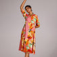Model wearing a summer pink cotton dress with vibrant floral patterns, perfect for warm weather styling