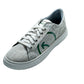 Stylish sustainable fashion sneakers for women with a light gray canvas upper and green logo accents