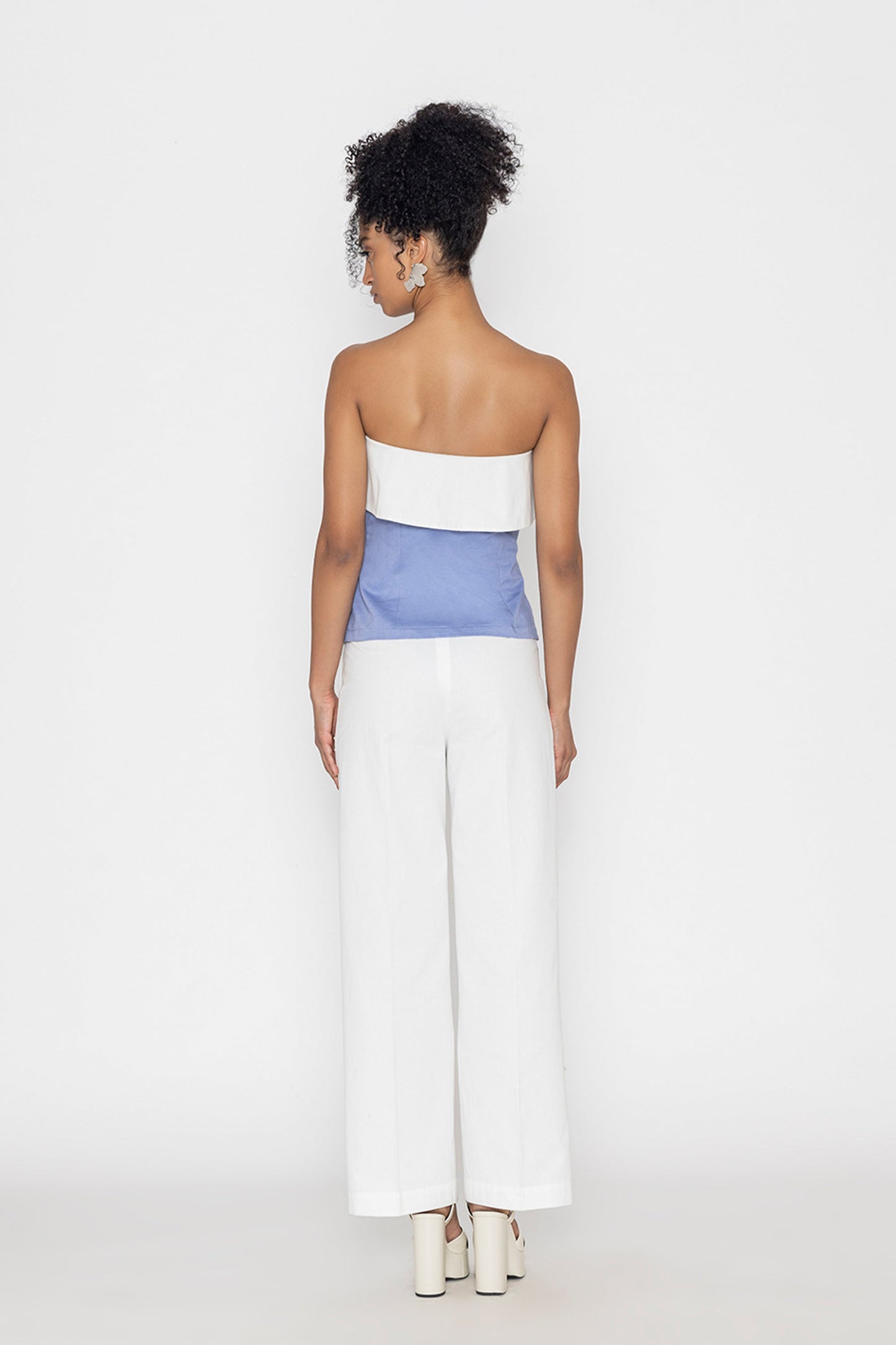 Stylera strapless blue and white swan lake inspired fashion top worn with white wide-leg pants