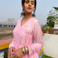 Elegant model wearing a taffy pink anarkali suit set with beautiful earrings and bangles