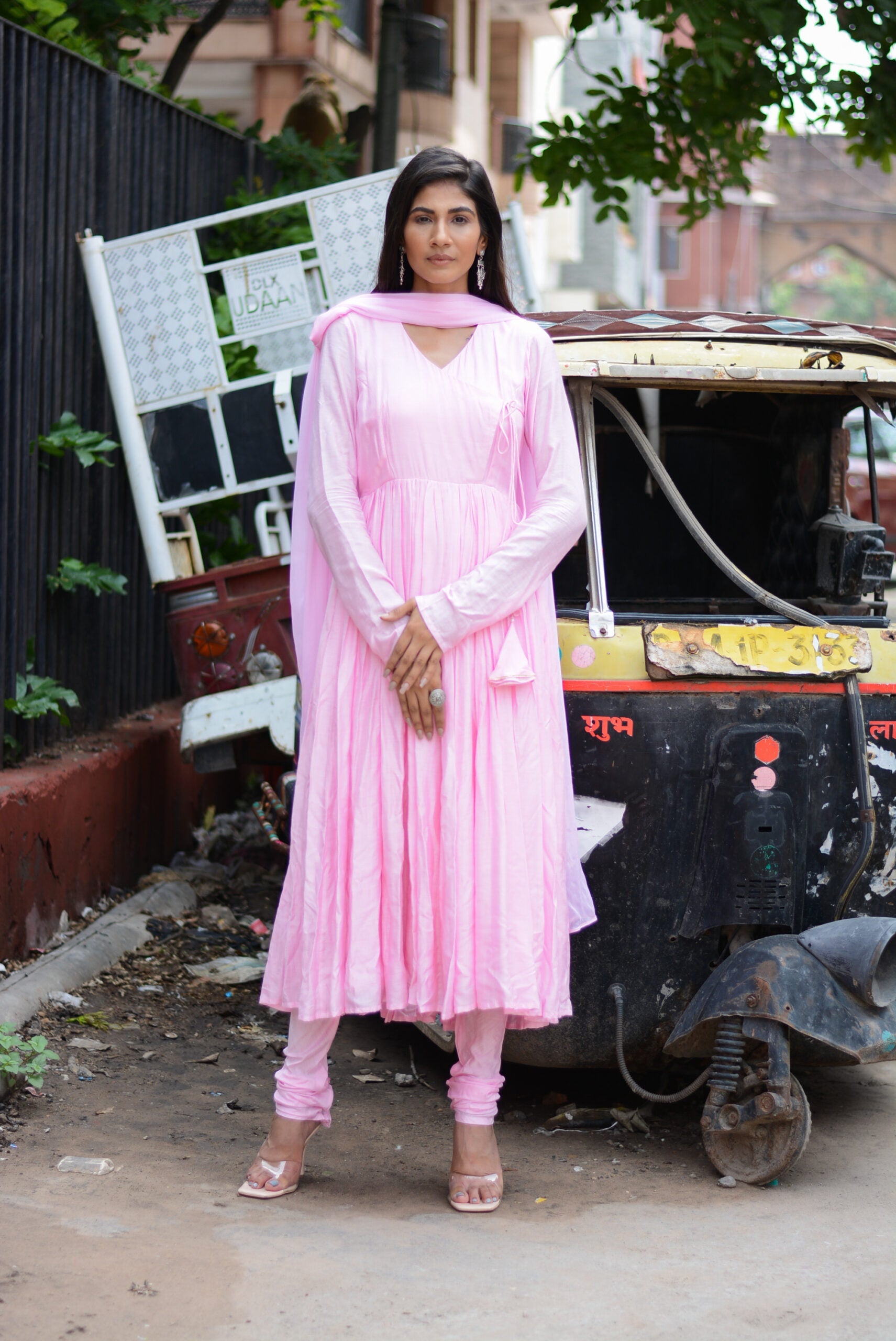 Model wearing a taffy pink anarkali suit set with a matching dupatta and leggings