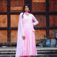 Model wearing a taffy pink anarkali suit set with elegant draping and matching bottoms