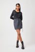 Stylera Tate cowl neck dress in black with long sleeves and a waist tie worn with black ankle boots