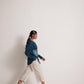 Woman wearing a teal cotton shirt for women with embroidery by Stylera walking in beige pants