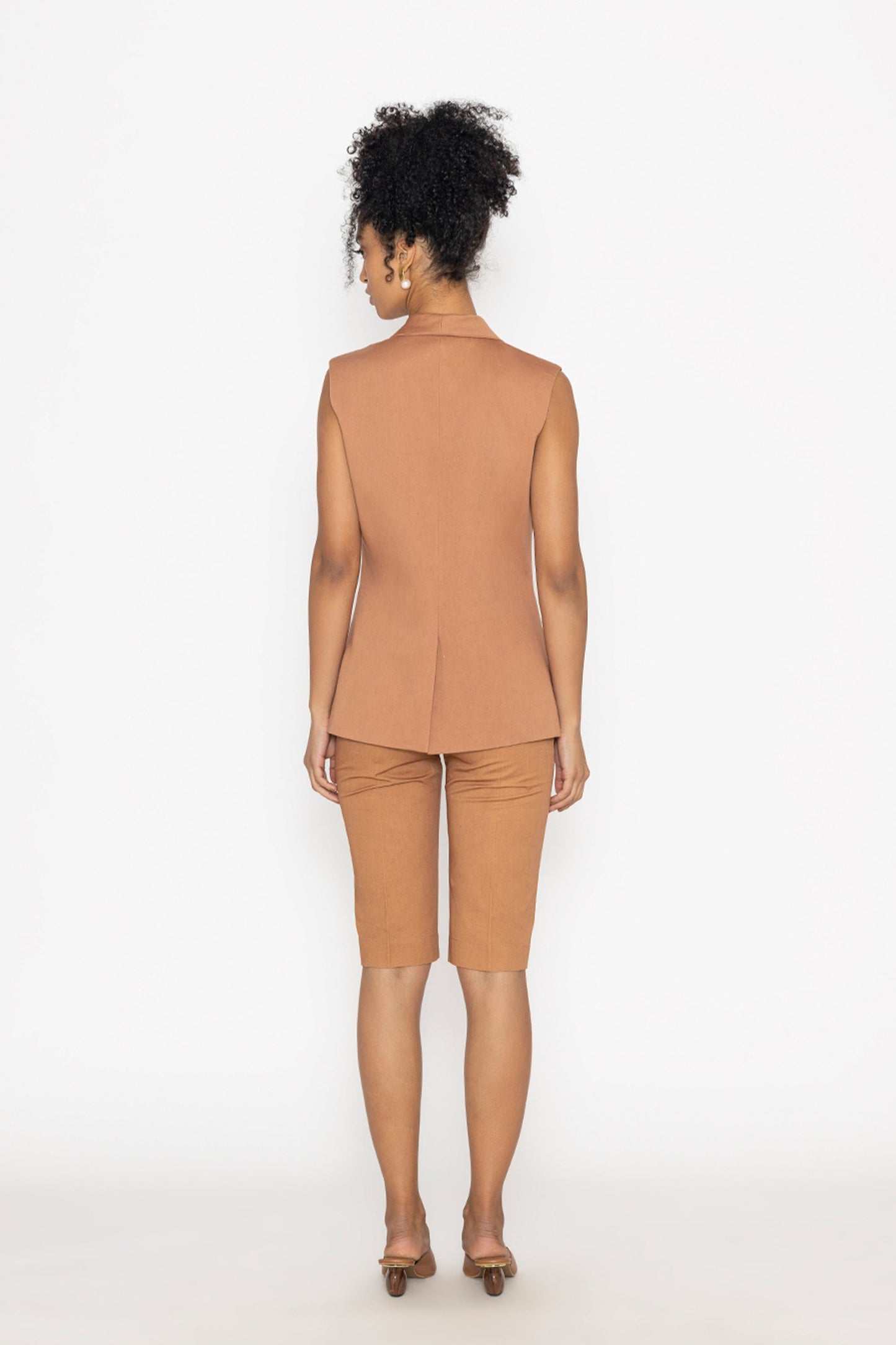 Back view of woman wearing terra color fashion vest and matching shorts by Stylera