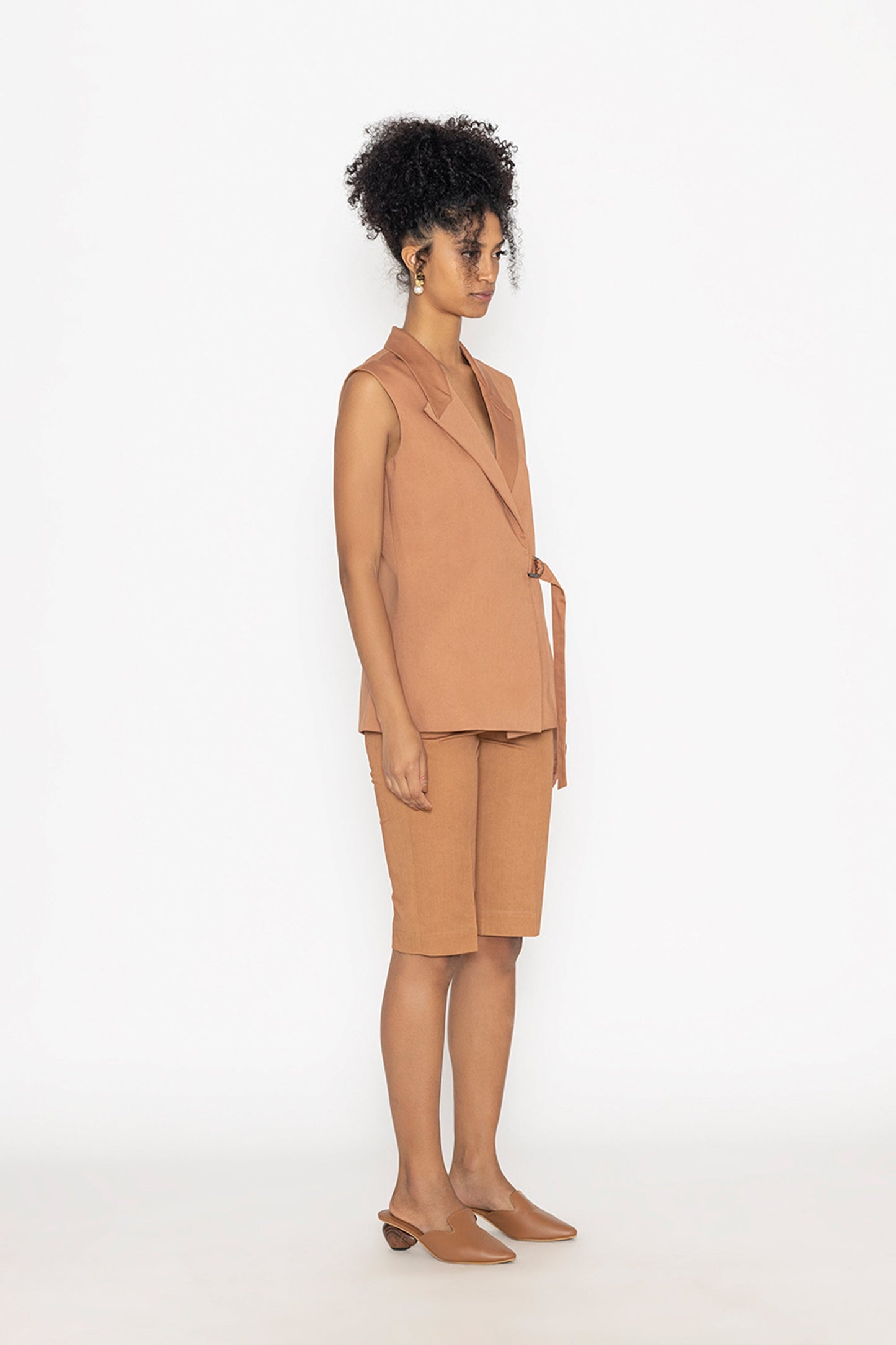 Stylera terra color fashion vest worn by model with matching shorts and brown slip-on shoes