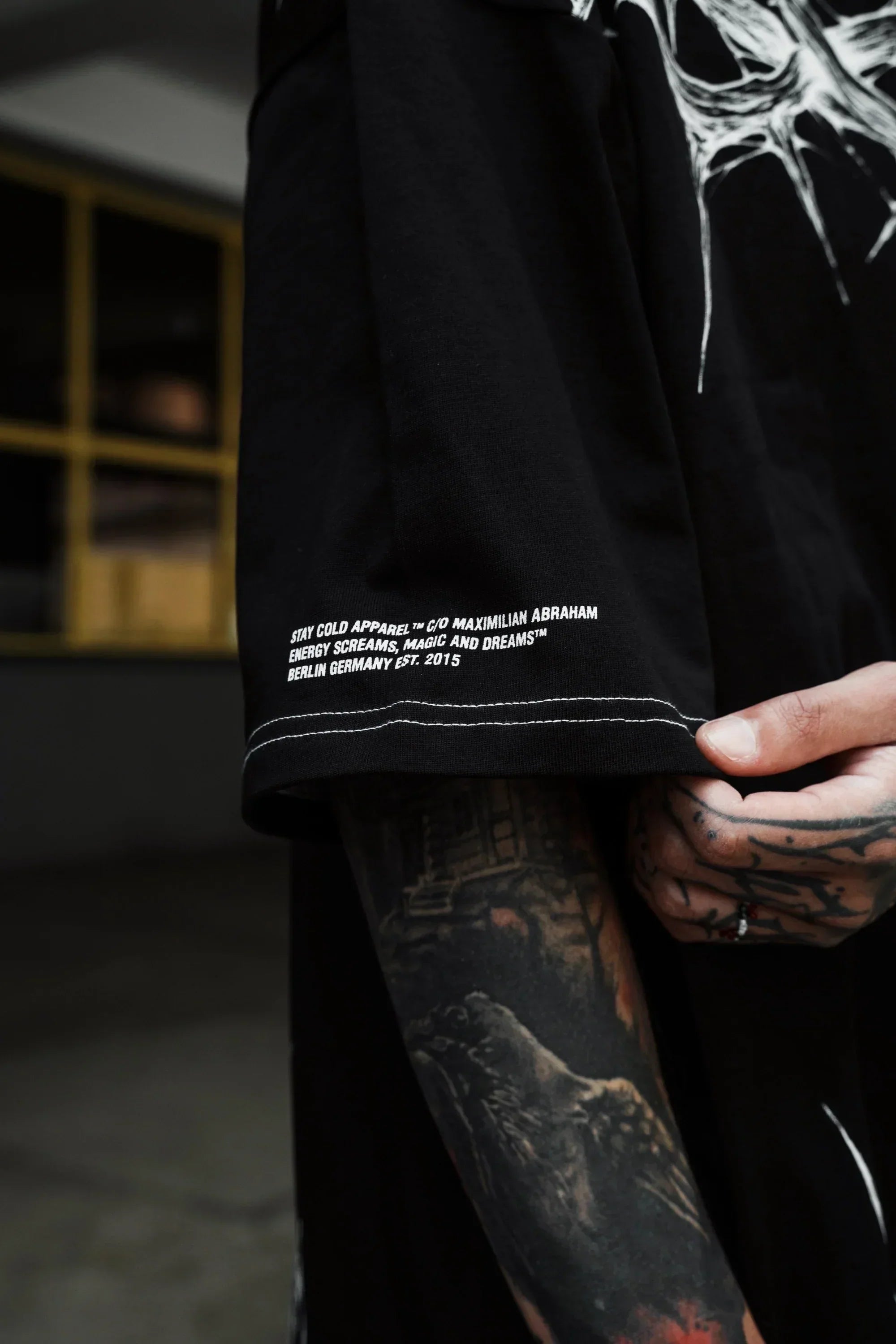 Back view showing the relaxed, edgy streetwear tshirt silhouette crafted in 240 GSM black cotton